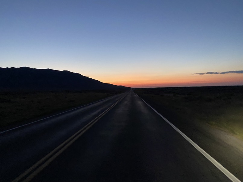 Sunrise revealing the straight and flat highway.